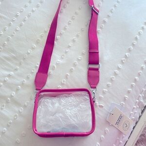 New with tags.  Clear bag with dark pink trim/strap.